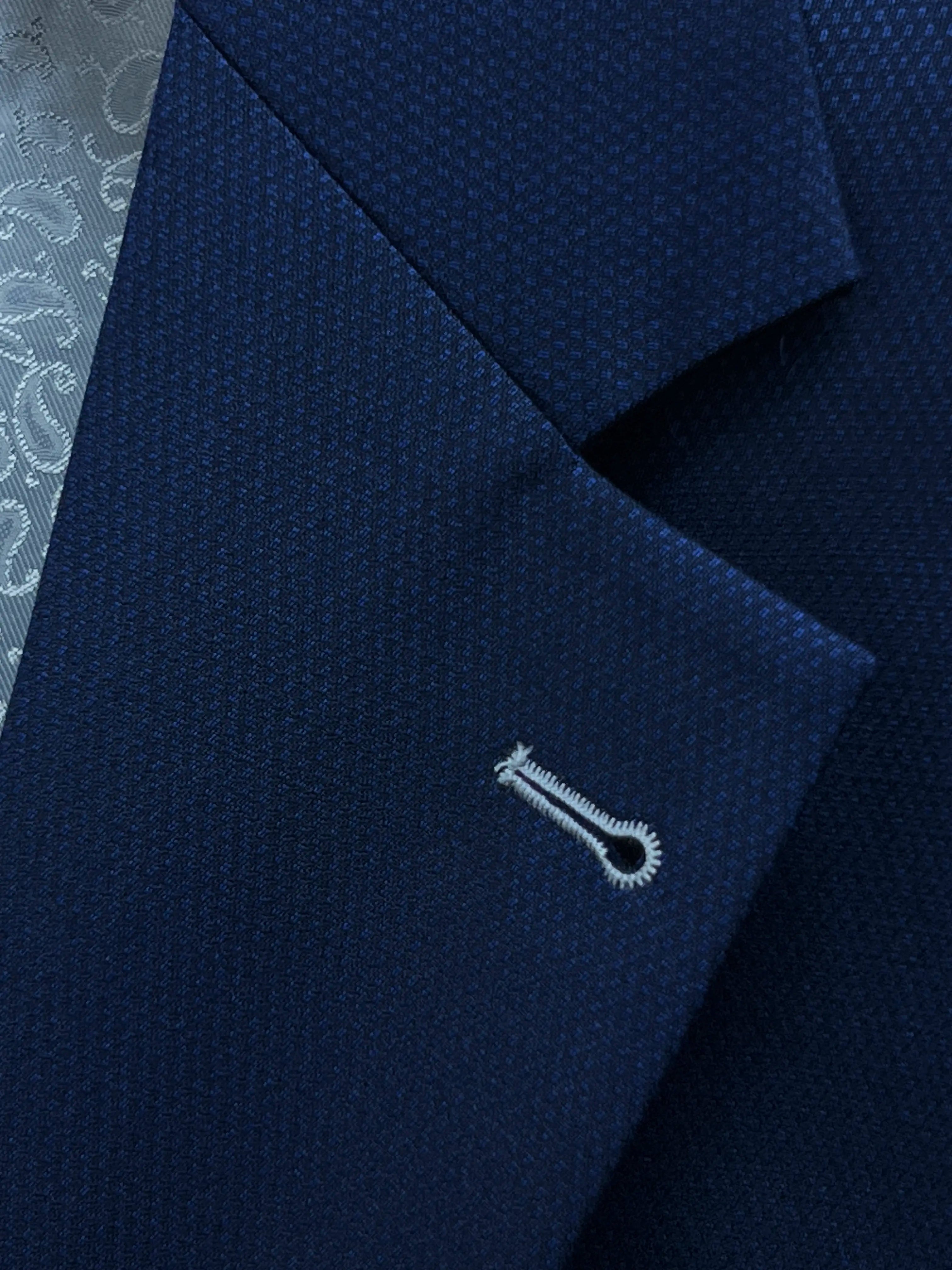 Lapel close up of Royal blue Birdseye men's sport coat showing the ivory contrast lapel buttonhole