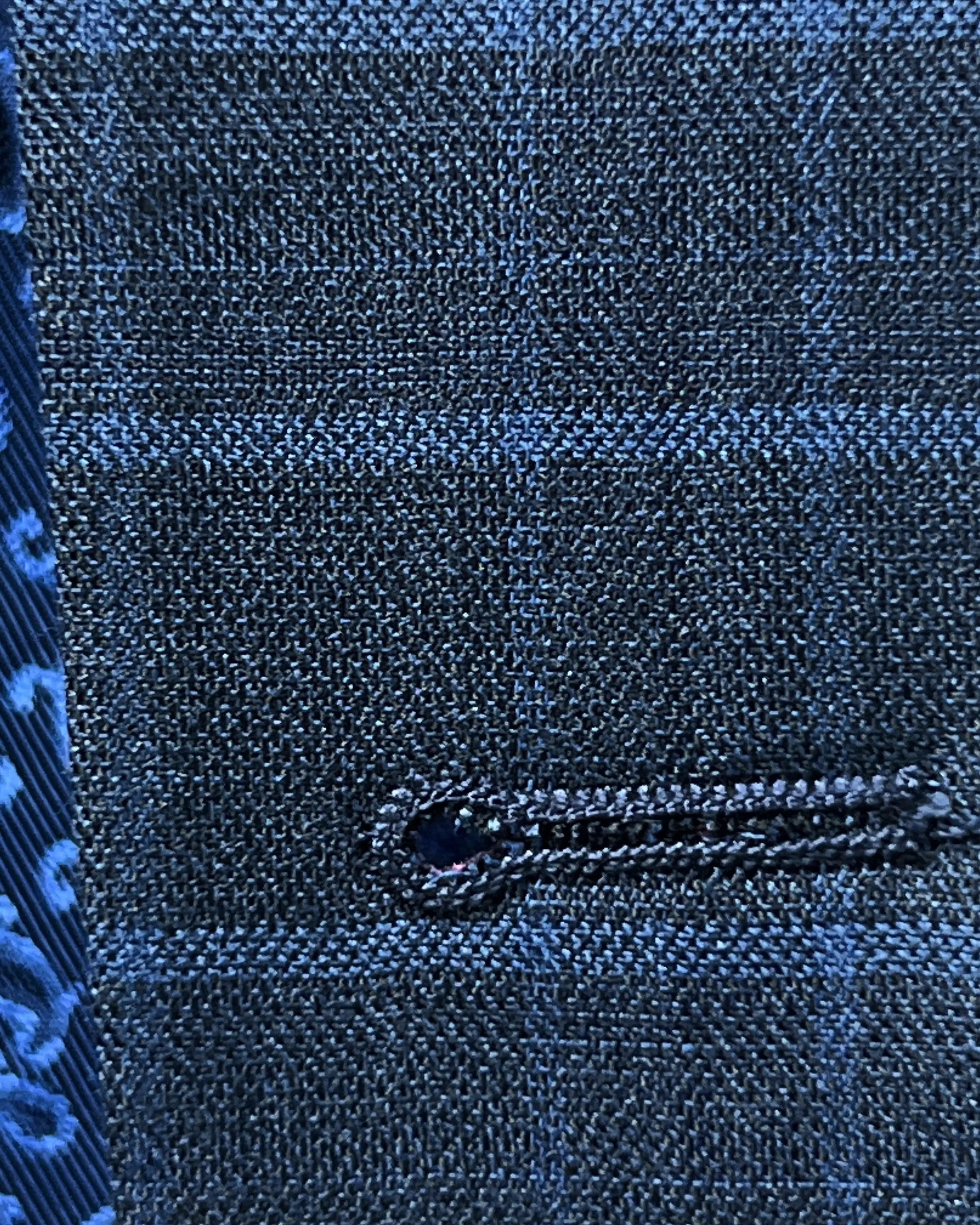 Buttonhole close up of slate blue windowpane check men's sport coat showing clean stitched front buttonhole detail