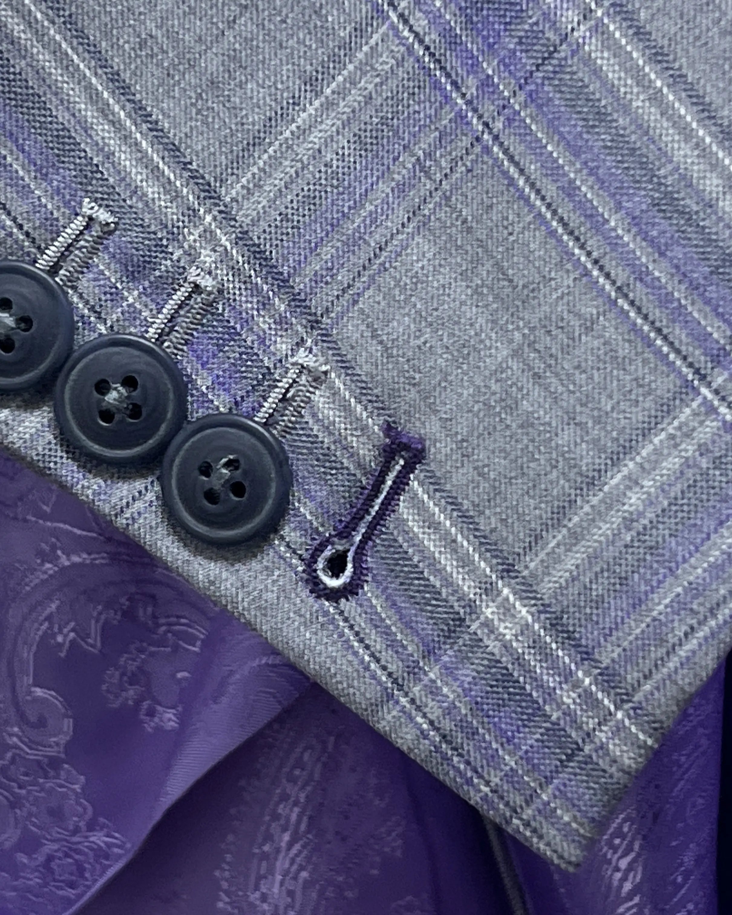 Sleeve cuff close up of Steel Grey Windowpane men's sport coat showing functional sleeve buttons and deep purple contrast buttonhole thread.