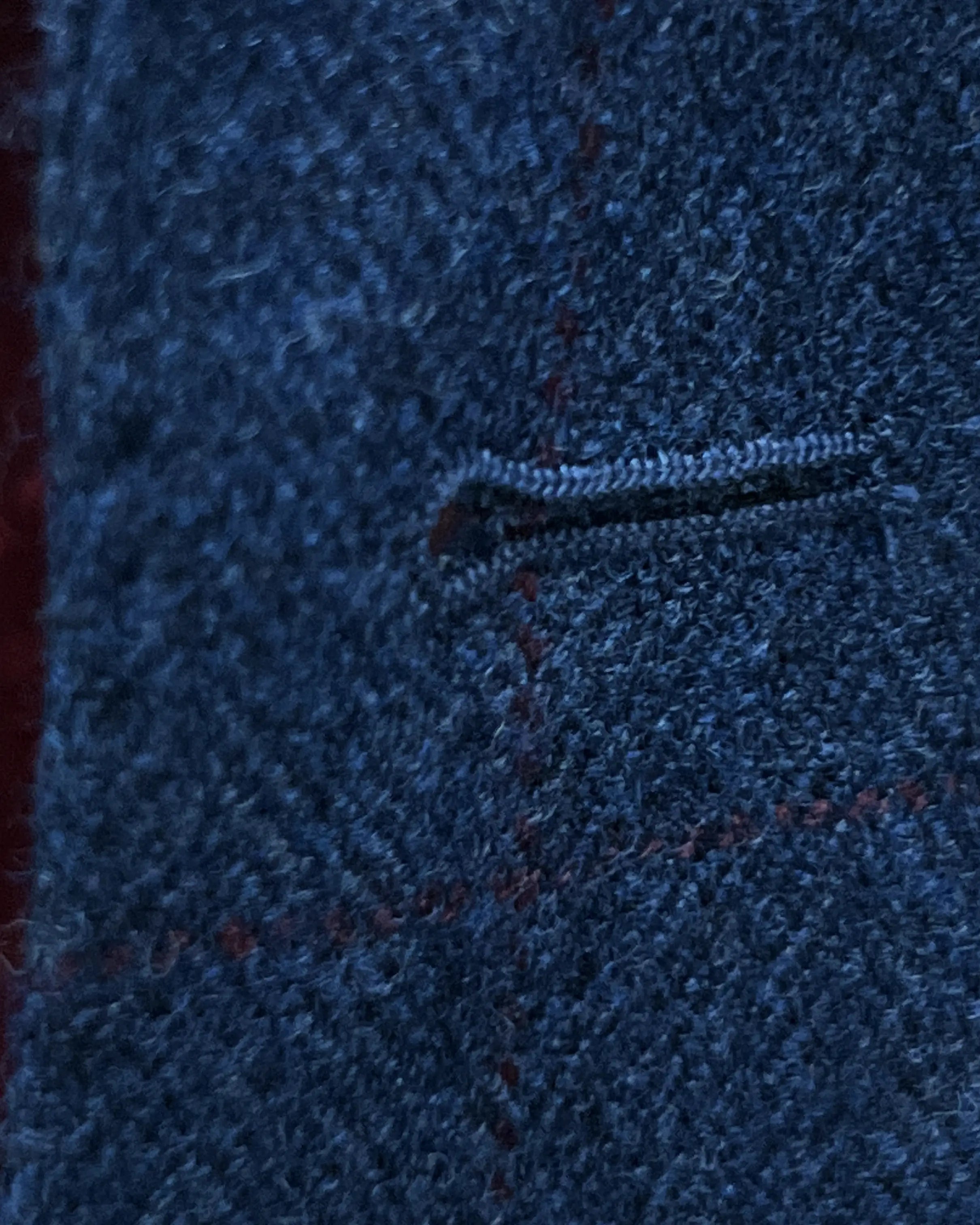 Buttonhole detail of teal blue with red windowpane men's sport coat showing the front buttonhole finish