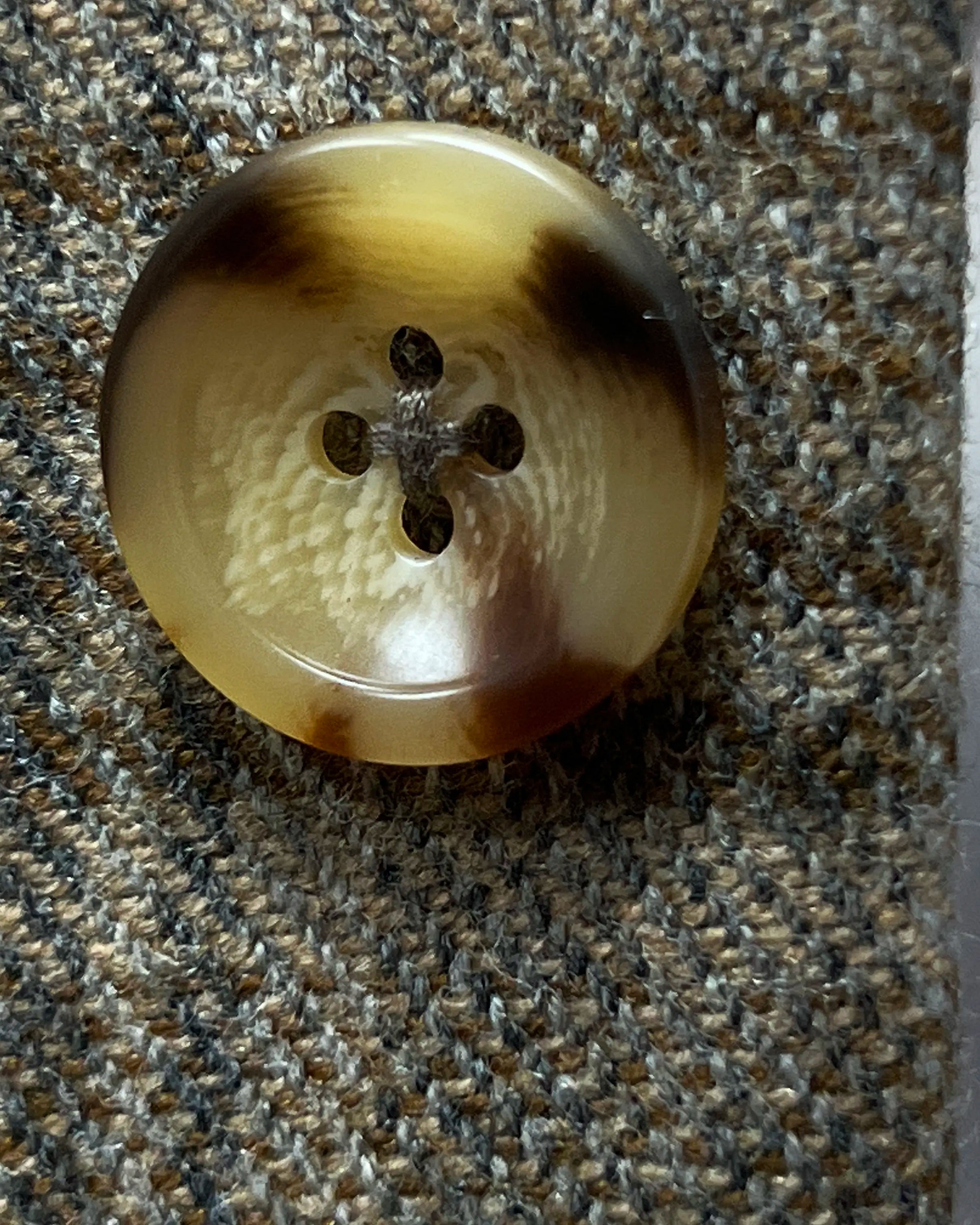 Button detail of Warm Taupe Textured Check men's sport coat showing tan horn buttons