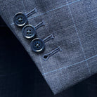 Close-up of working sleeve buttonholes with navy horn buttons on jacket cuff