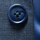 Macro shot of navy horn buttons showing natural marble pattern