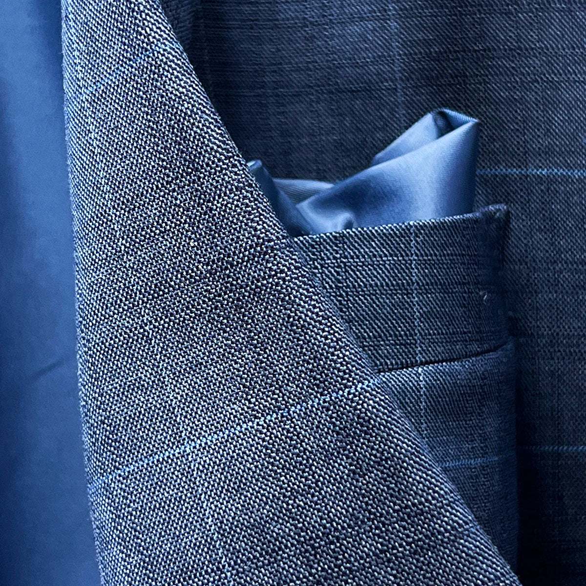 Detail shot of decorative flash lining details in navy Bemberg silk