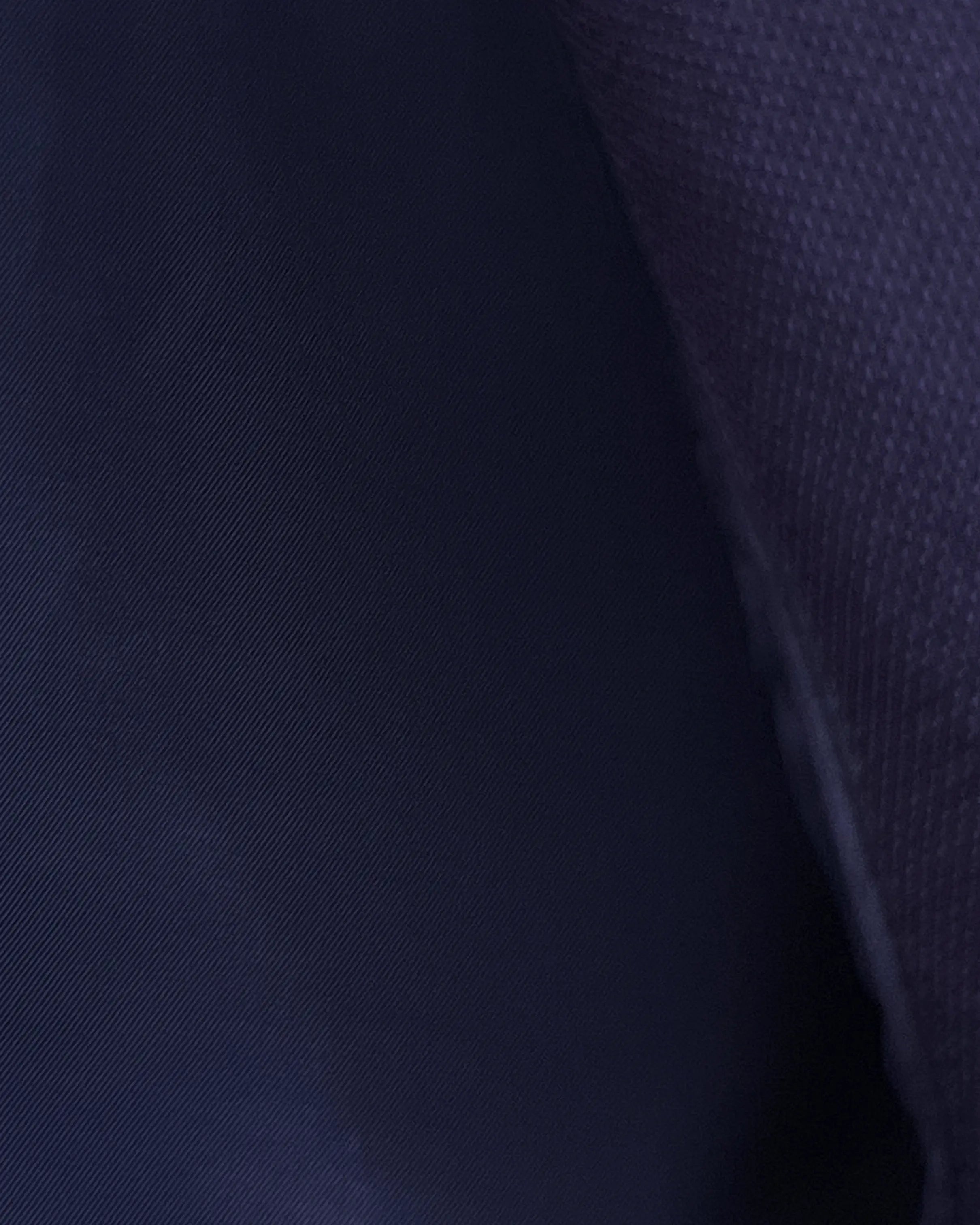 Interior lining close up of aubergine birdseye men's suit showing dark navy cupro silk bemberg lining.