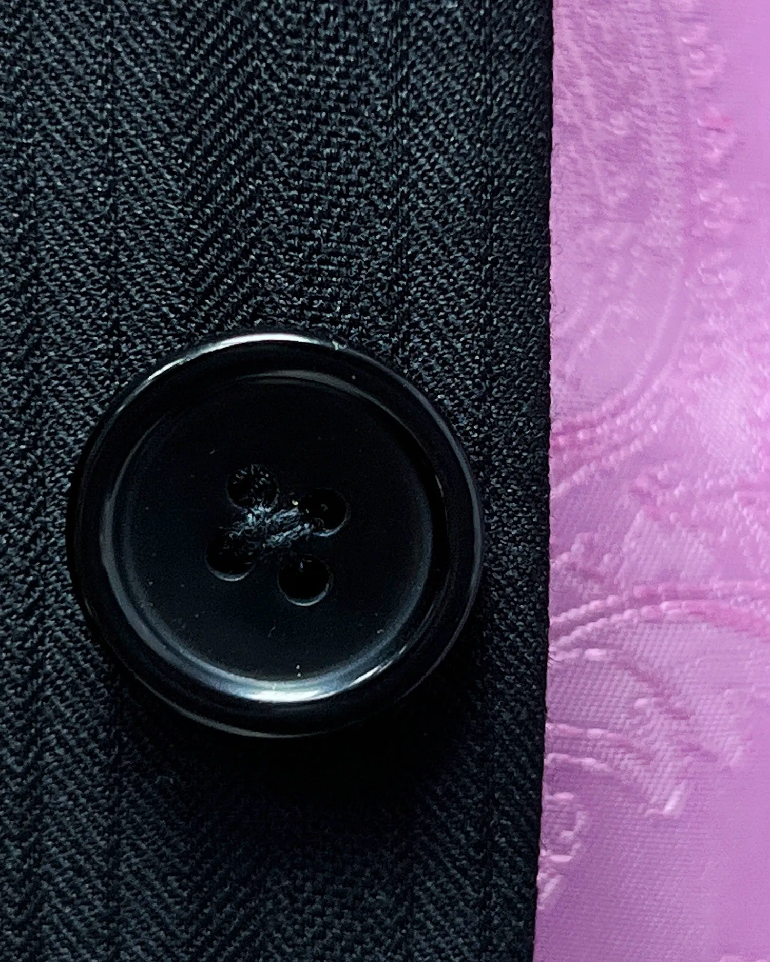Button detail of black herringbone with shadow stripes men's suit showing black horn buttons