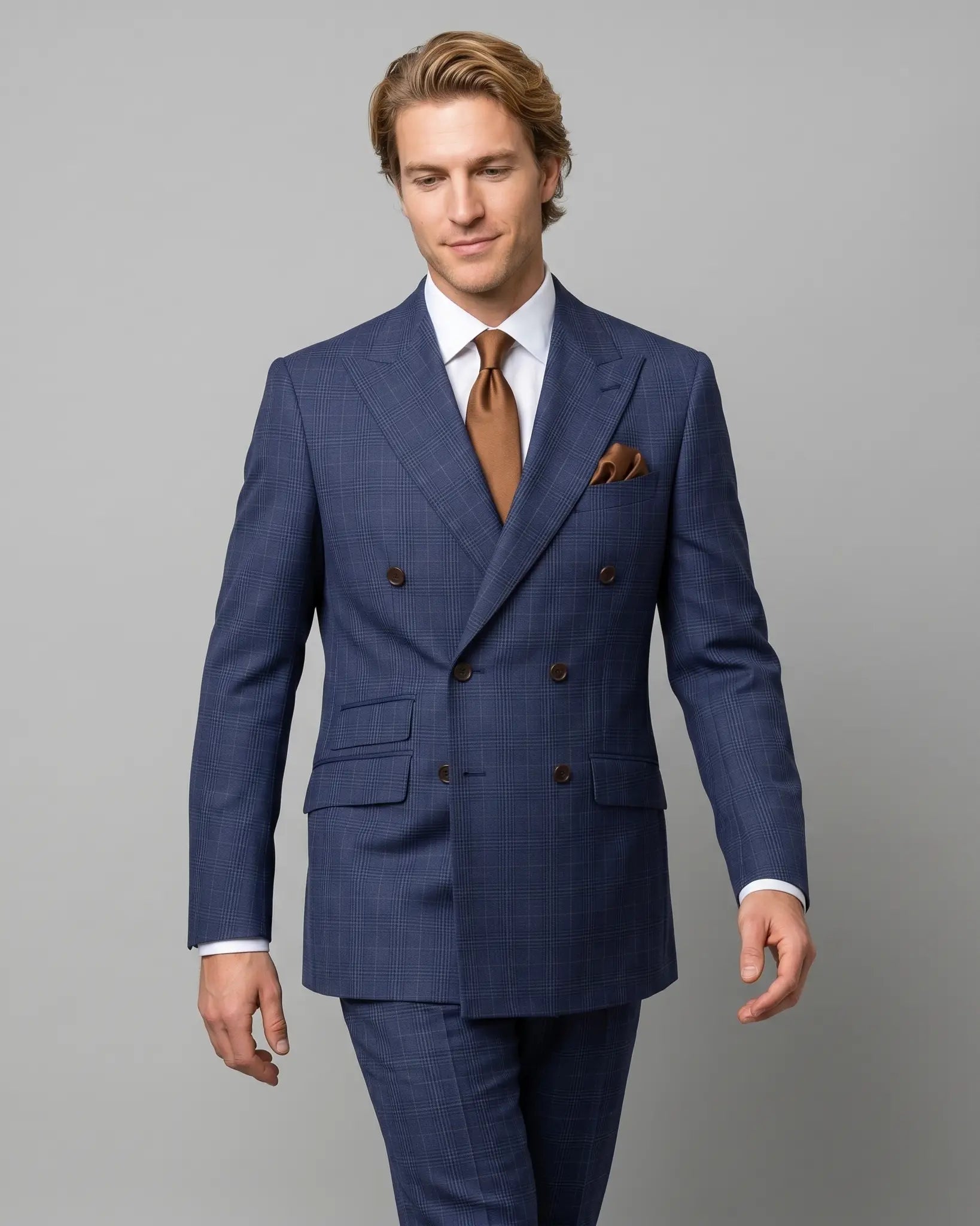 Angled model view of blue windowpane plaid men's suit showing peak lapel and buttoned jacket front