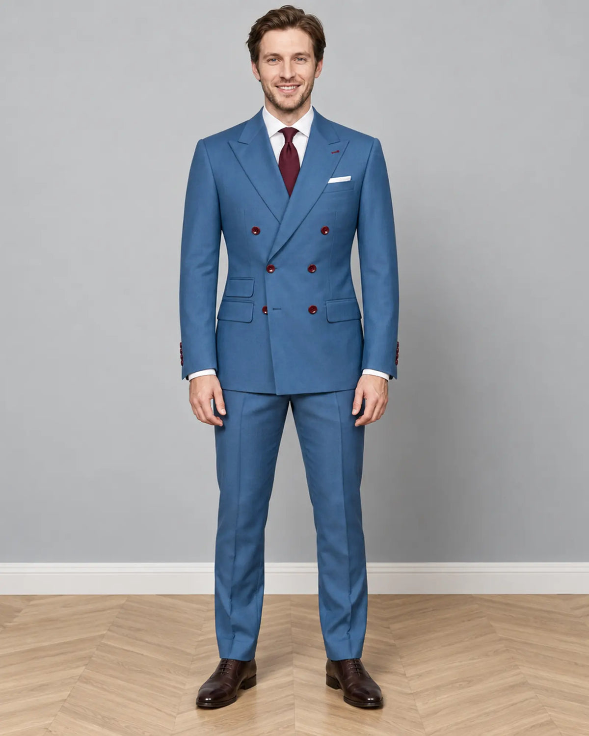 Full body front view of cornflower blue solid twill weave men's suit showing double breasted peak lapel styling
