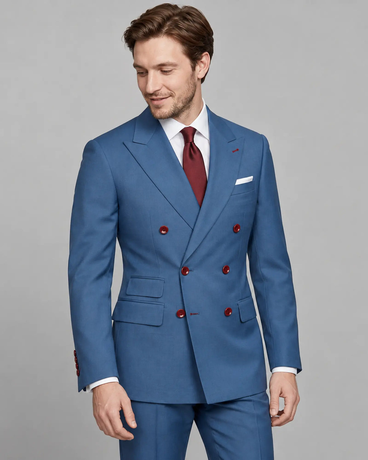 Mid thigh angled view of cornflower blue solid twill weave men's suit showing peak lapel construction