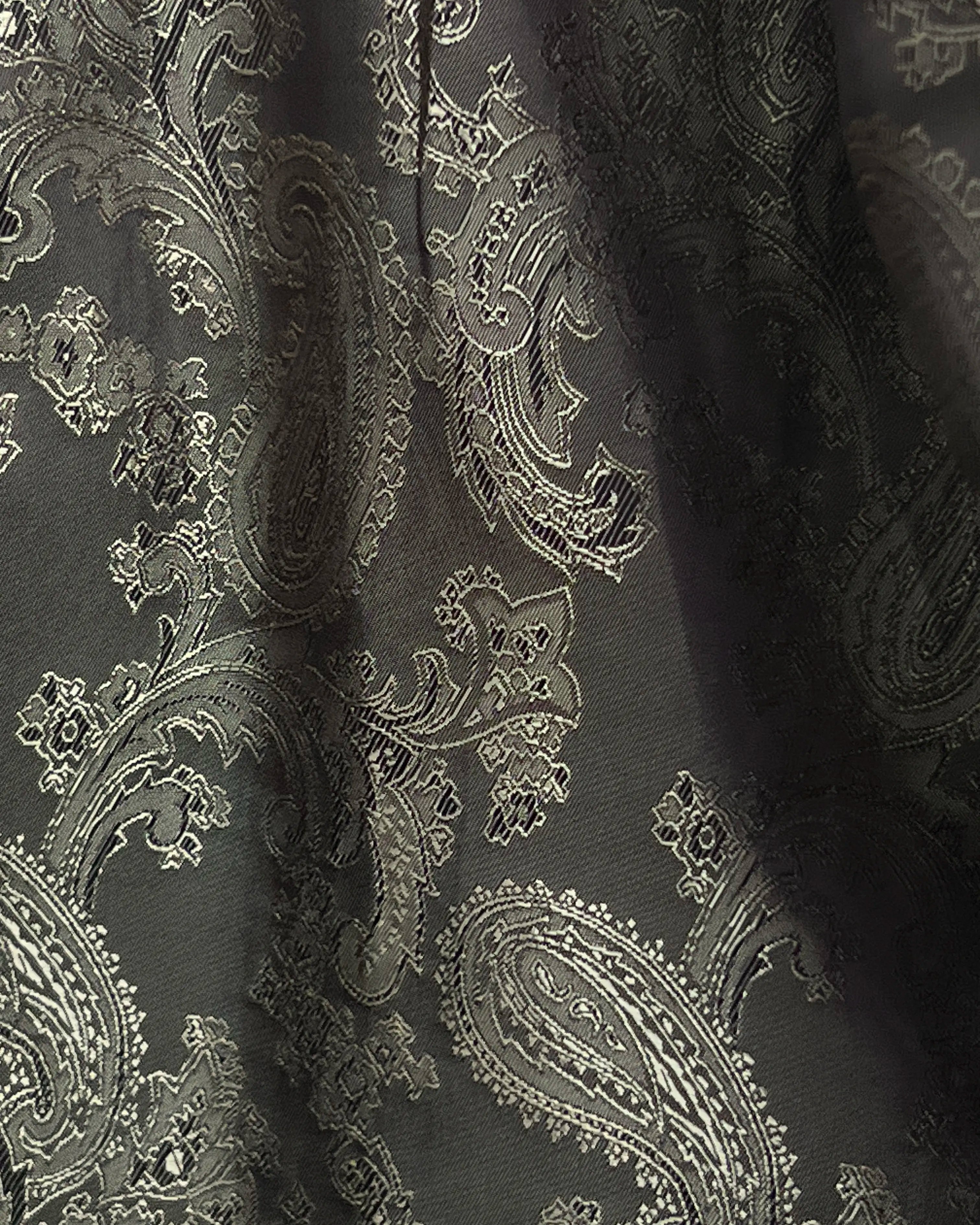 Lining close up of dark forest green herringbone men's suit showing paisley bemberg silk lining