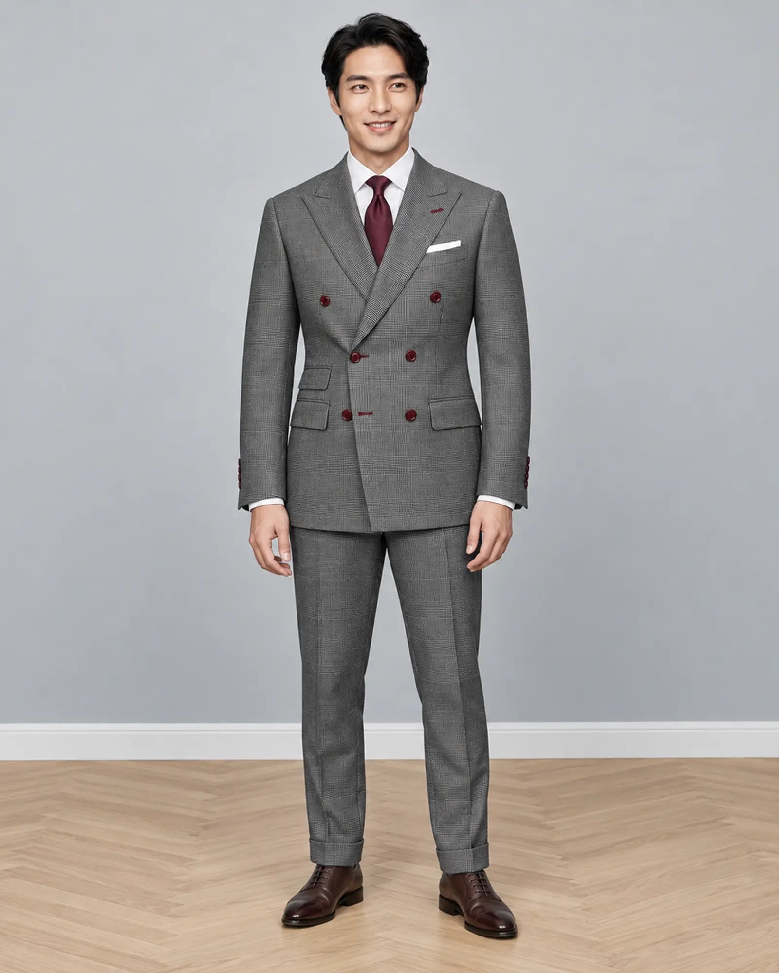 Full body front view of grey houndstooth Prince of Wales Glen plaid men's suit showing double breasted peak lapel styling