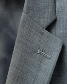 Lapel buttonhole close up of grey sharkskin men's suit showing standard lapel buttonhole stitching