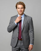Mid length side view of grey sharkskin men's suit showing lapel shape and natural jacket opening