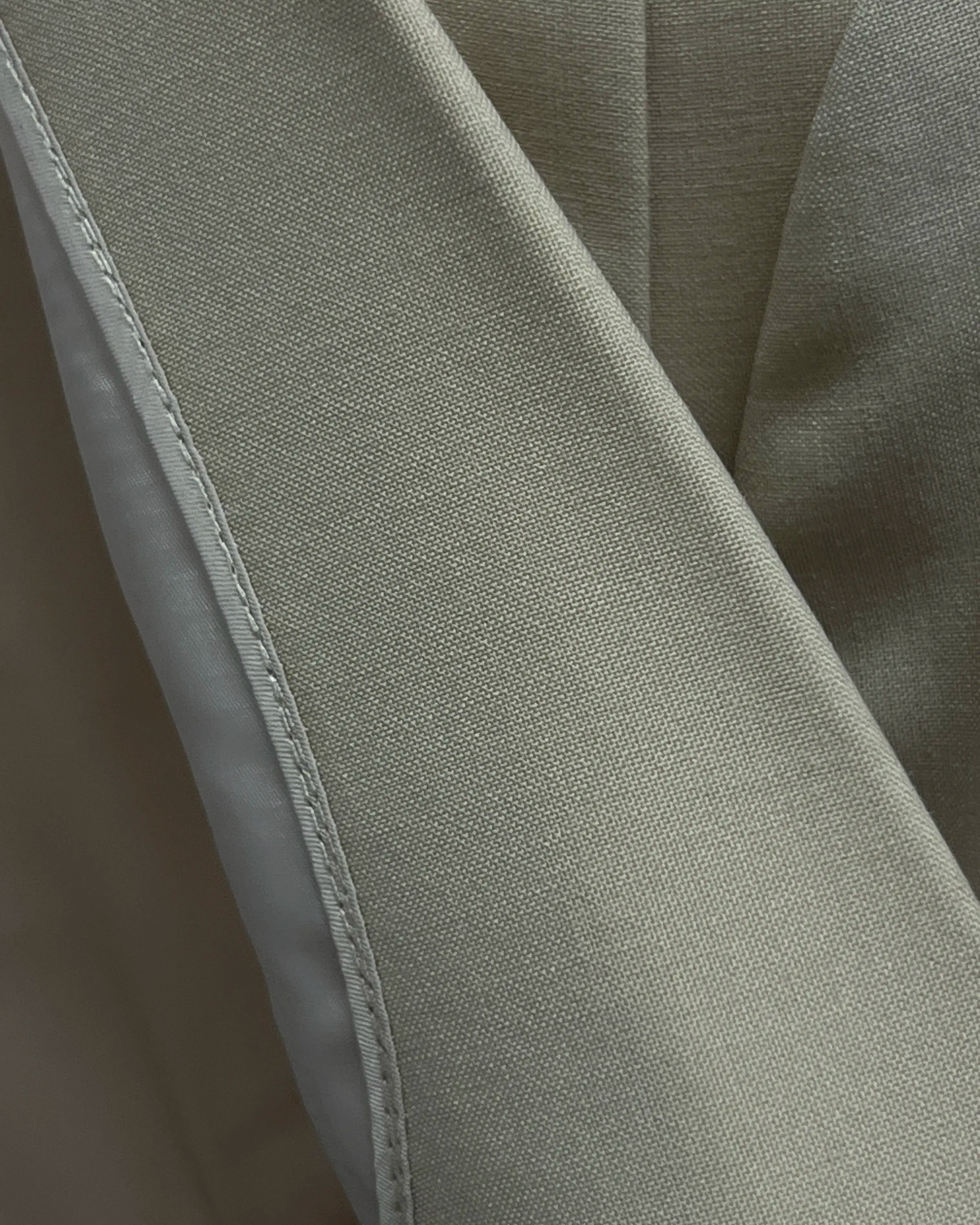 Fabric cloth texture close up of light beige plain men's suit showing plain wool surface