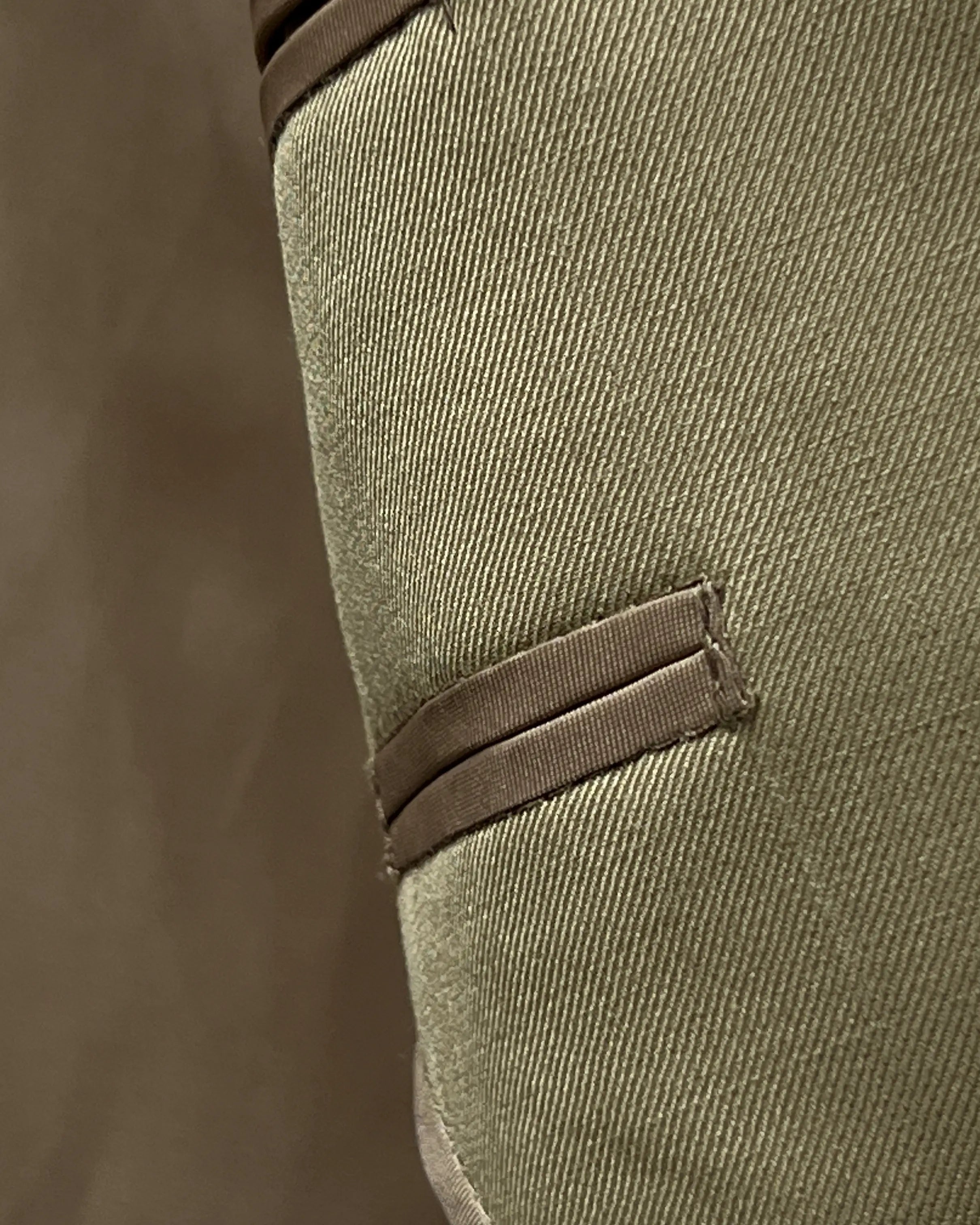Fabric close up of brown plain men's suit showing smooth worsted diagonal twill texture
