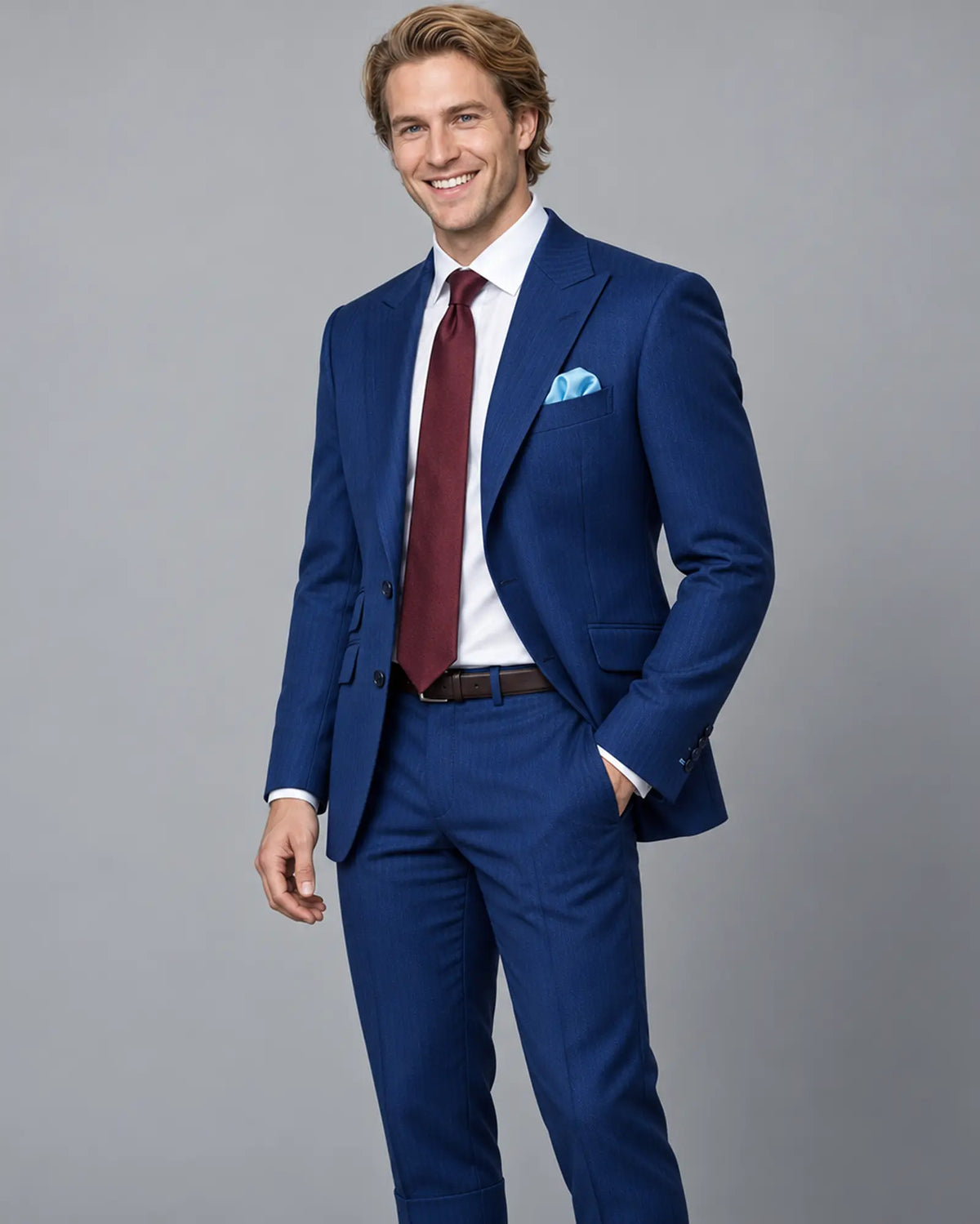 Mid thigh model view of royal blue herringbone men's suit showing peak lapels and natural jacket drape