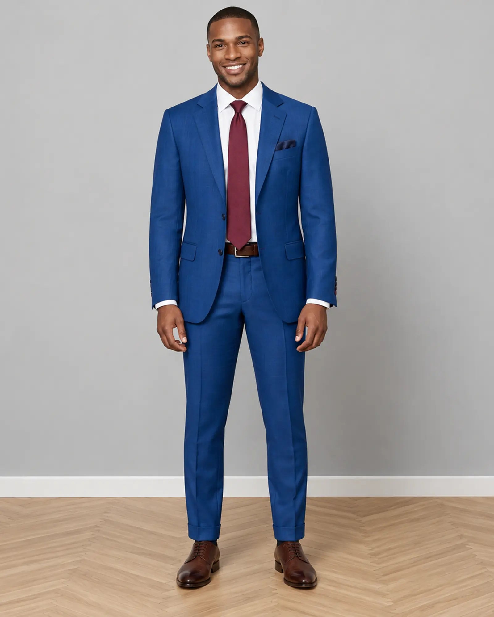 Full body front view of royal blue Prince of Wales glen check with rust overcheck men's suit showing the complete tailored silhouette