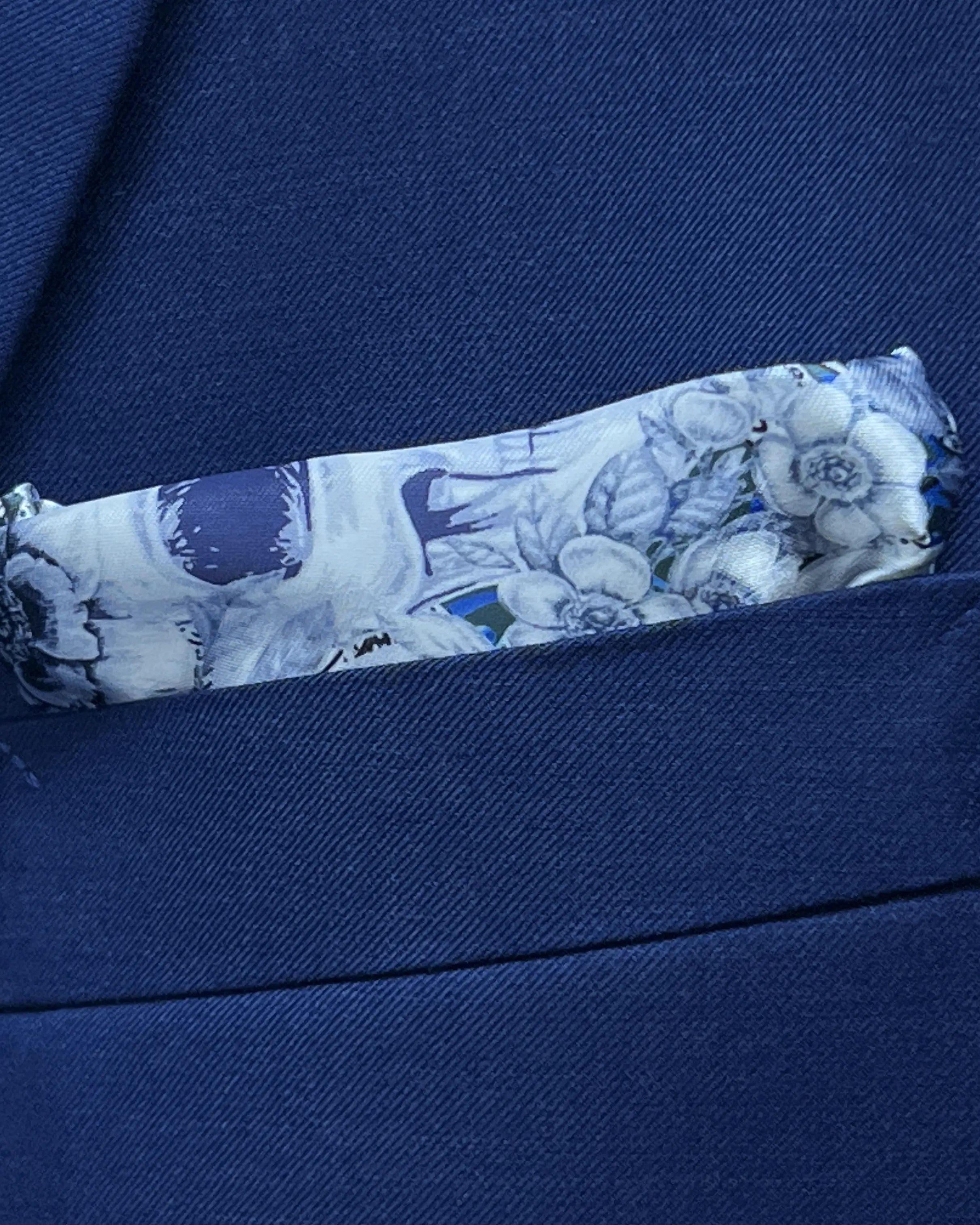 Breast pocket detail of royal blue sharkskin men's suit showing the matching Blue Skulls lining pocket square.