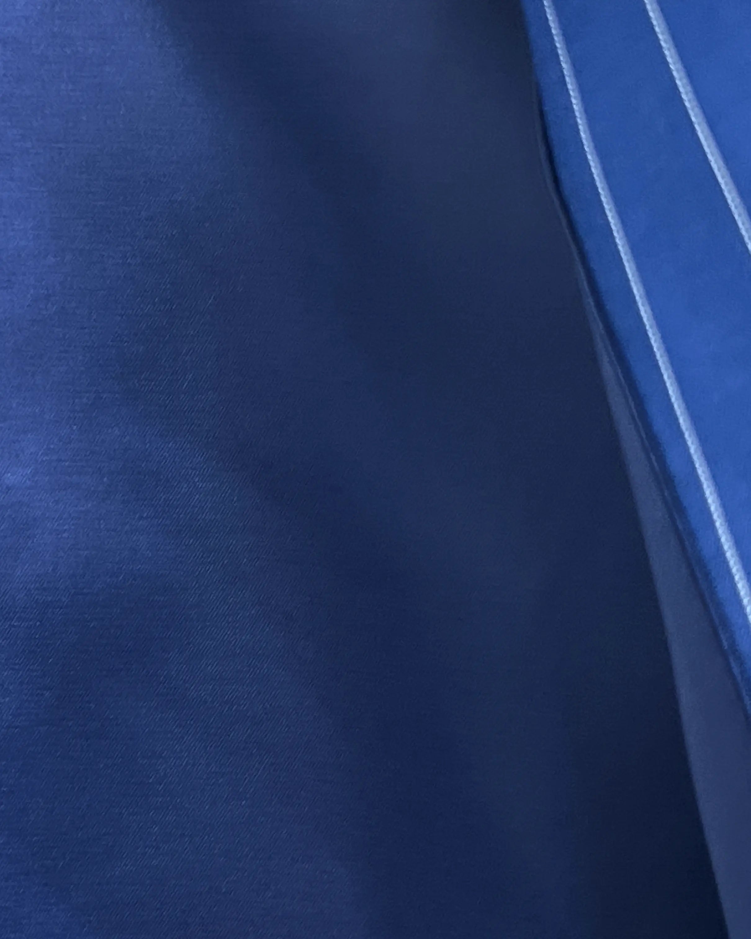 Lining close up of royal blue white pinstripes men's suit showing royal blue silk bemberg lining