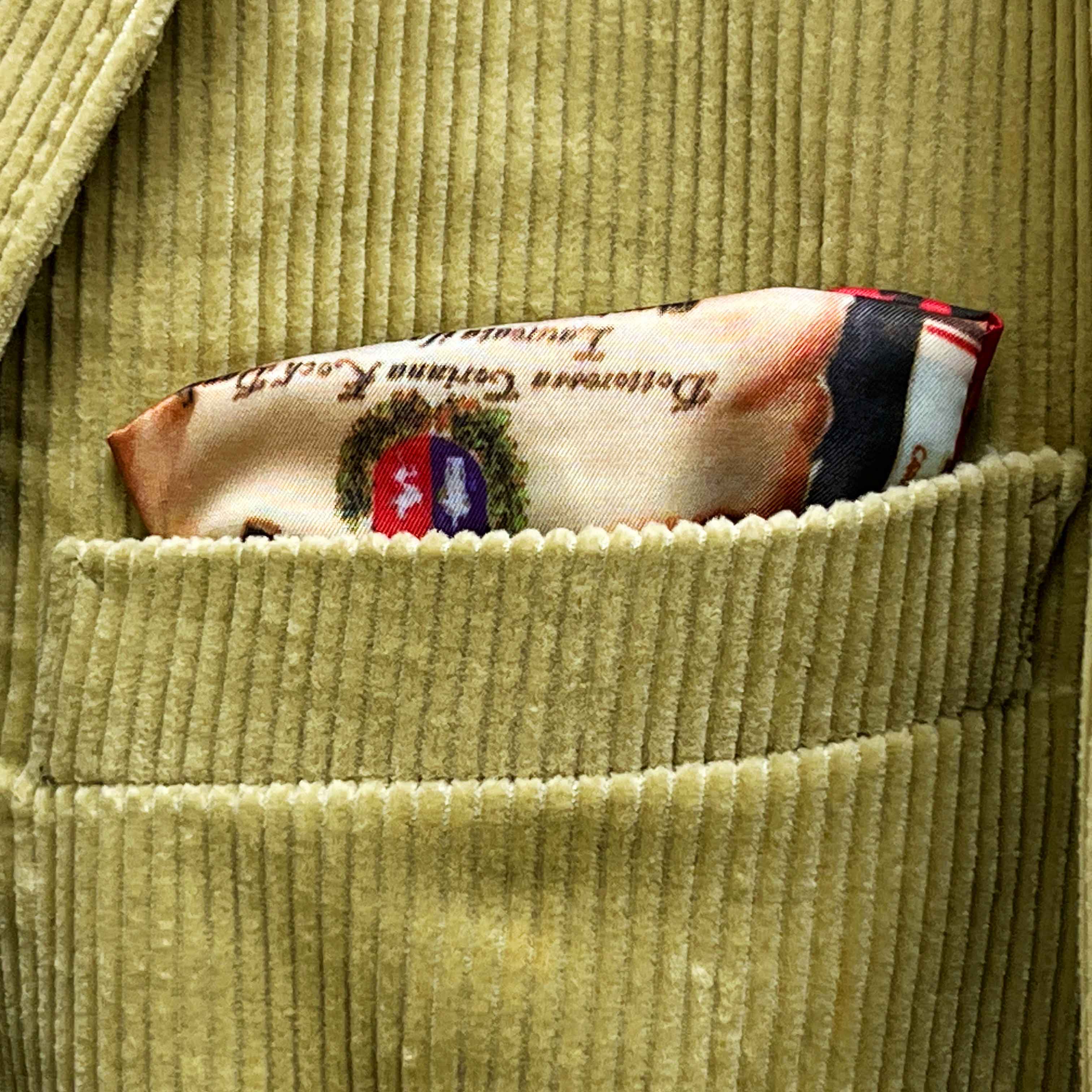 Breast pocket of tan corduroy sport coat with hand-finished edges and pick stitching detail