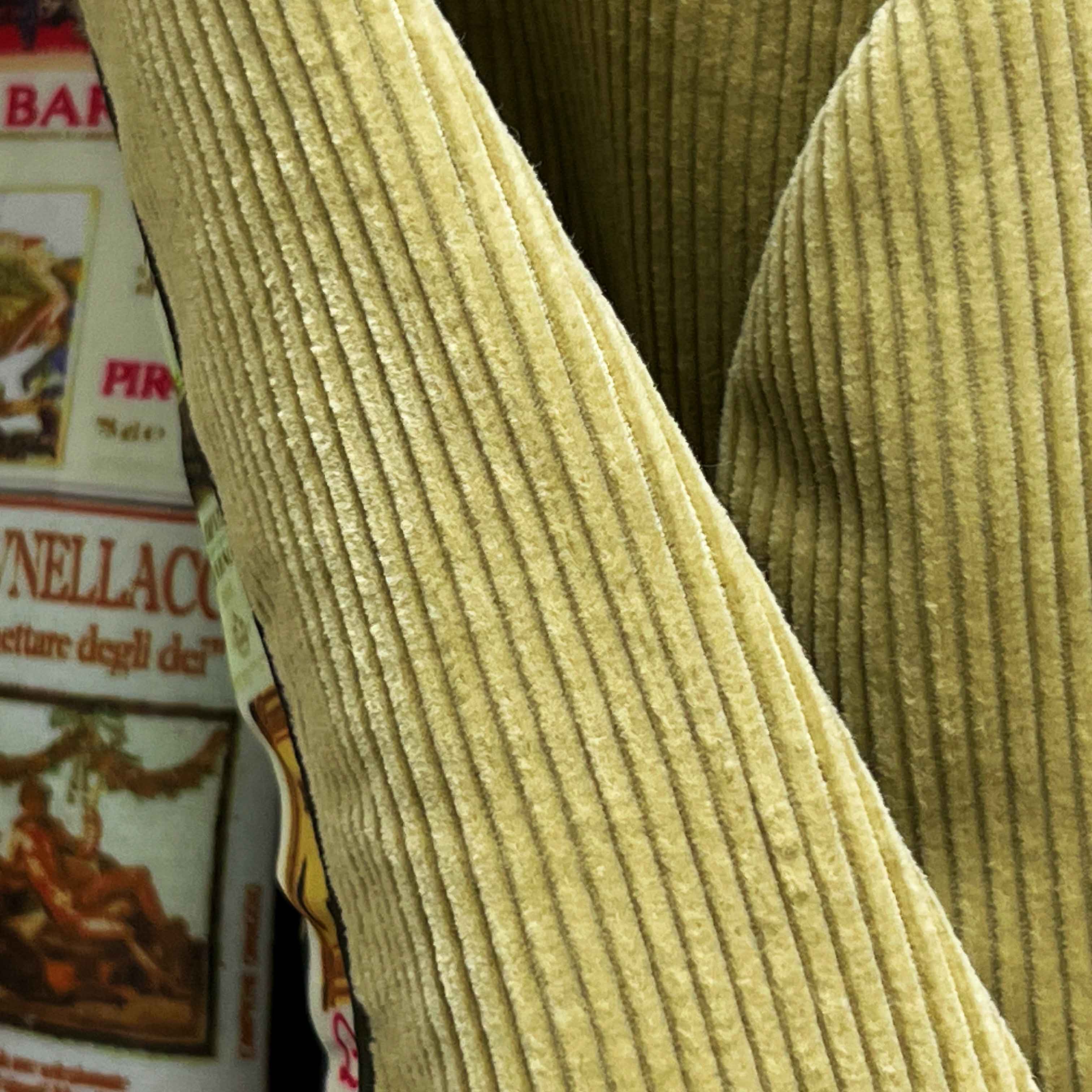 Close-up of 10-wale corduroy fabric texture on tan sport coat showing vertical ribbed pattern and soft pile