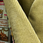 Close-up of 10-wale corduroy fabric texture on tan sport coat showing vertical ribbed pattern and soft pile