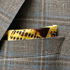 Breast pocket of tan blue windowpane sport coat with built-in pocket square holder and hand-finished edges