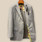 Interior left side of tan blue windowpane sport coat displaying vibrant yellow multicolored mosaic lining with inner pocket