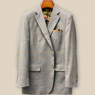 Front button panel of tan blue windowpane sport coat featuring tan and deep brown horn buttons with hand pick stitching
