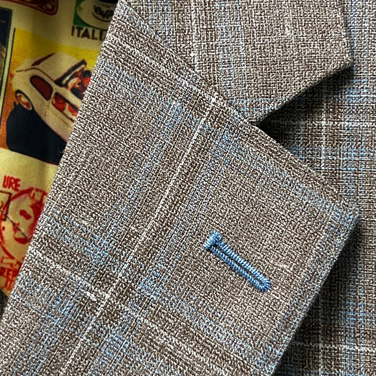 Classic notch lapel detail on tan blue windowpane sport coat showing hand pick stitching and blue check pattern