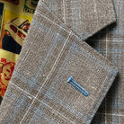 Classic notch lapel detail on tan blue windowpane sport coat showing hand pick stitching and blue check pattern