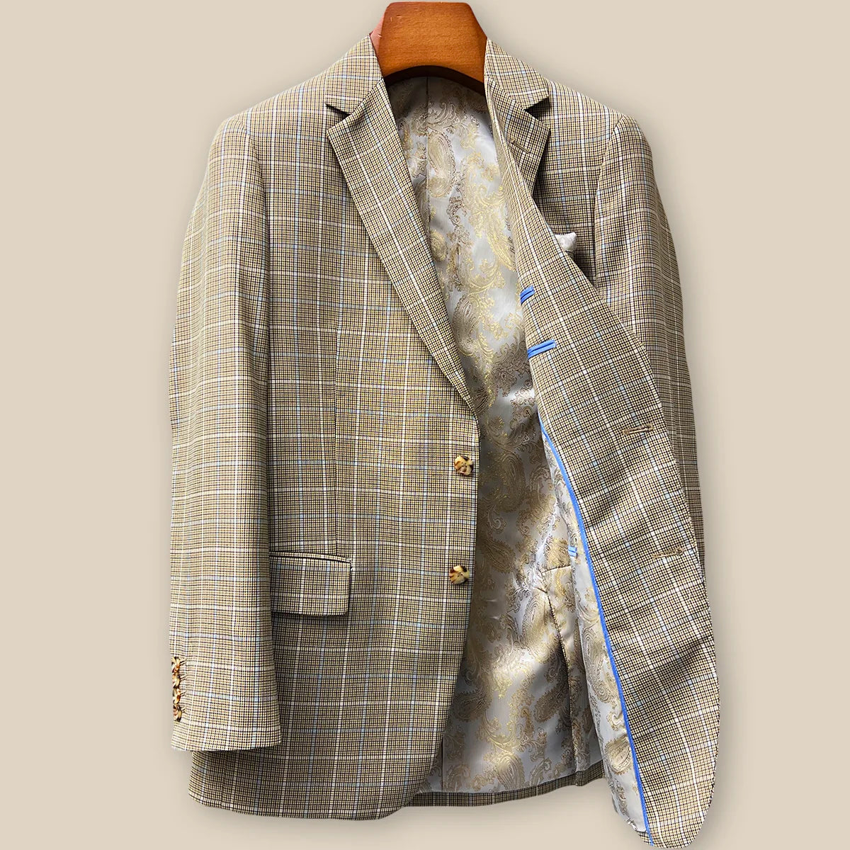 Interior left side of tan brown glen check sport coat displaying champagne gold paisley lining with inner pocket