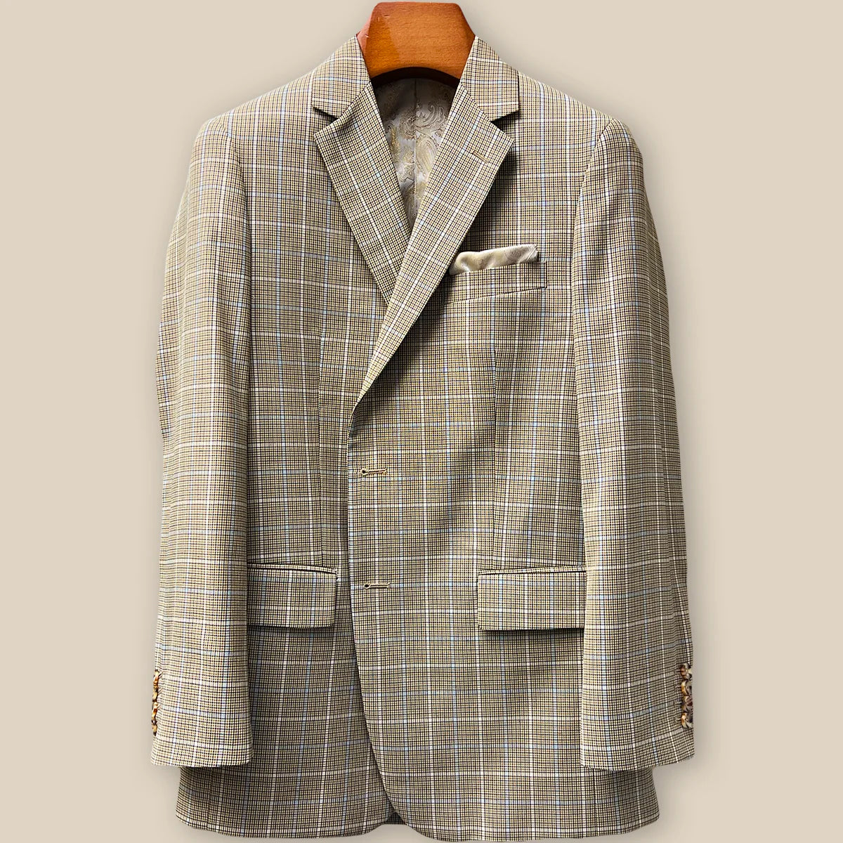 Close-up view of tan brown glen check sport coat jacket showing buttonhole panel with swirled caramel horn buttons