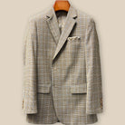Close-up view of tan brown glen check sport coat jacket showing buttonhole panel with swirled caramel horn buttons