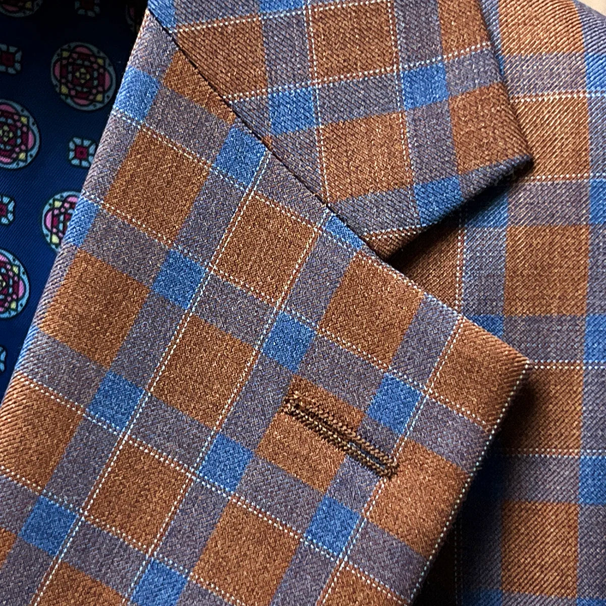 Classic notch lapel detail showcasing clean lines, proper proportions, and tobacco brown cobalt blue check pattern at lapel edge
