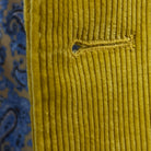 Detailed macro shot of hand-finished buttonhole stitching on warm mustard yellow corduroy sport coat with precision craftsmanship