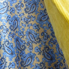 Colorful flash lining detail visible at jacket cuffs and vents in beige silk with blue paisley pattern
