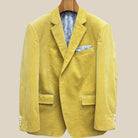 Close-up view of warm mustard yellow corduroy sport coat showing light cream horn buttons with caramel swirl and hand-finished pick stitching detail