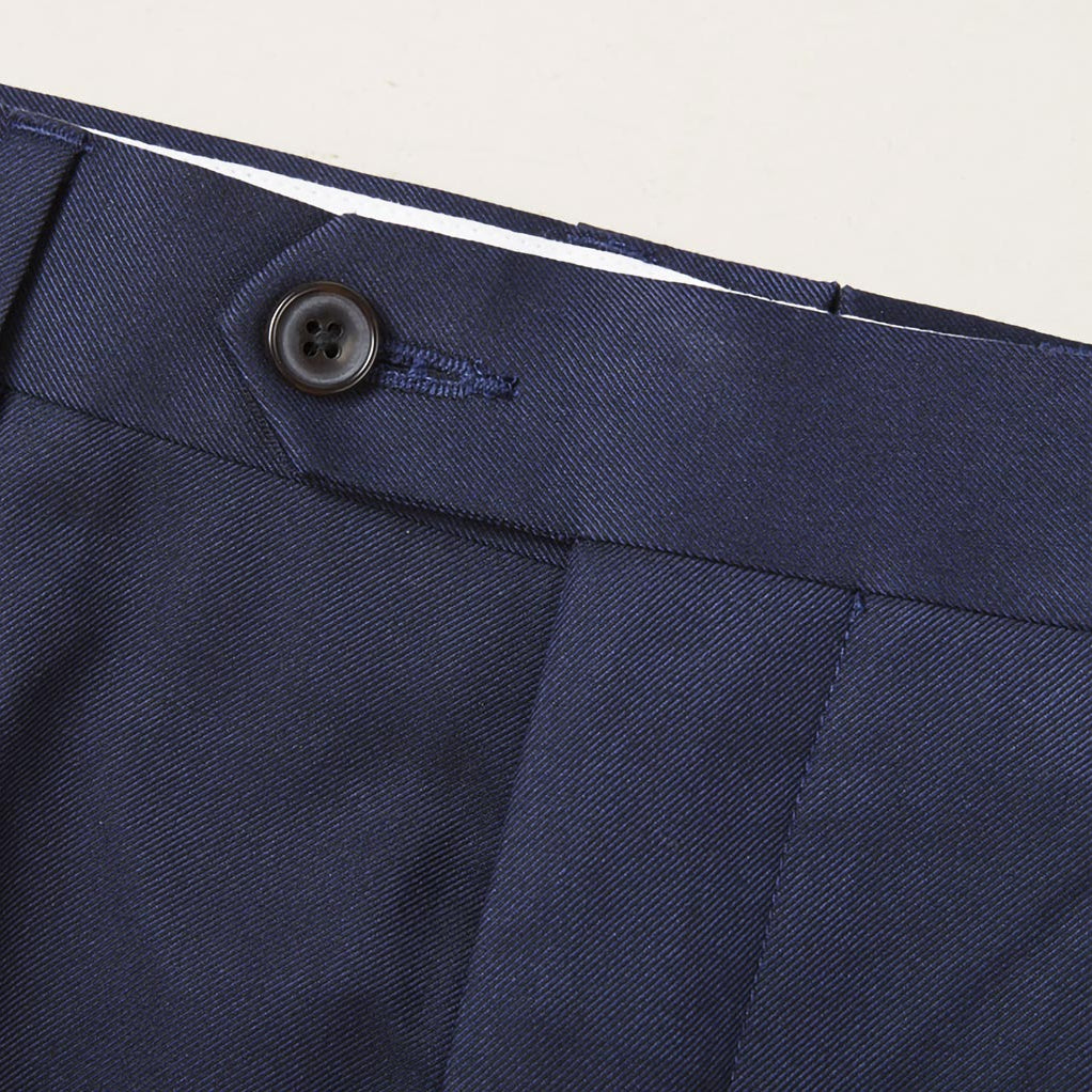 Custom tailored navy suit for work, showcasing the plain weave fabric and waistband of trousers