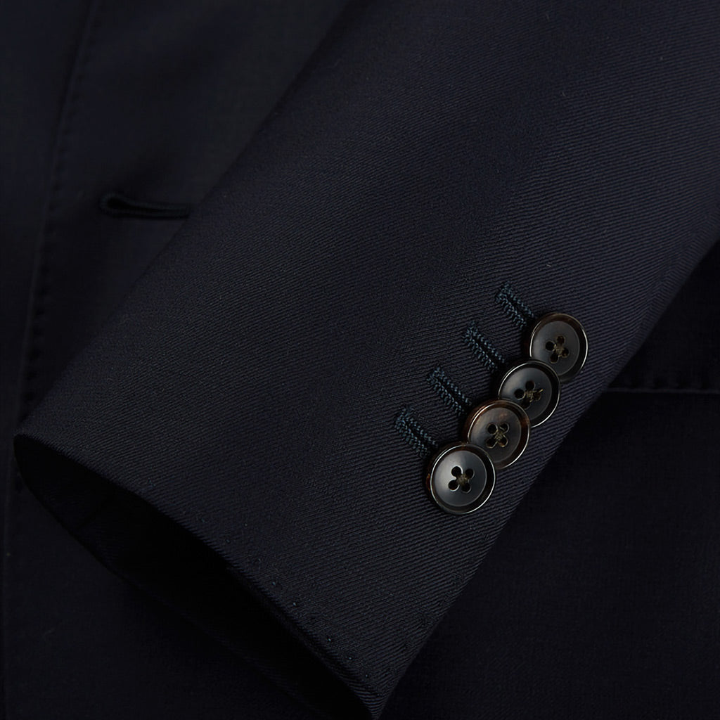 Plain weave black custom suit, close-up of the sleeve cuffs and buttons for work attire